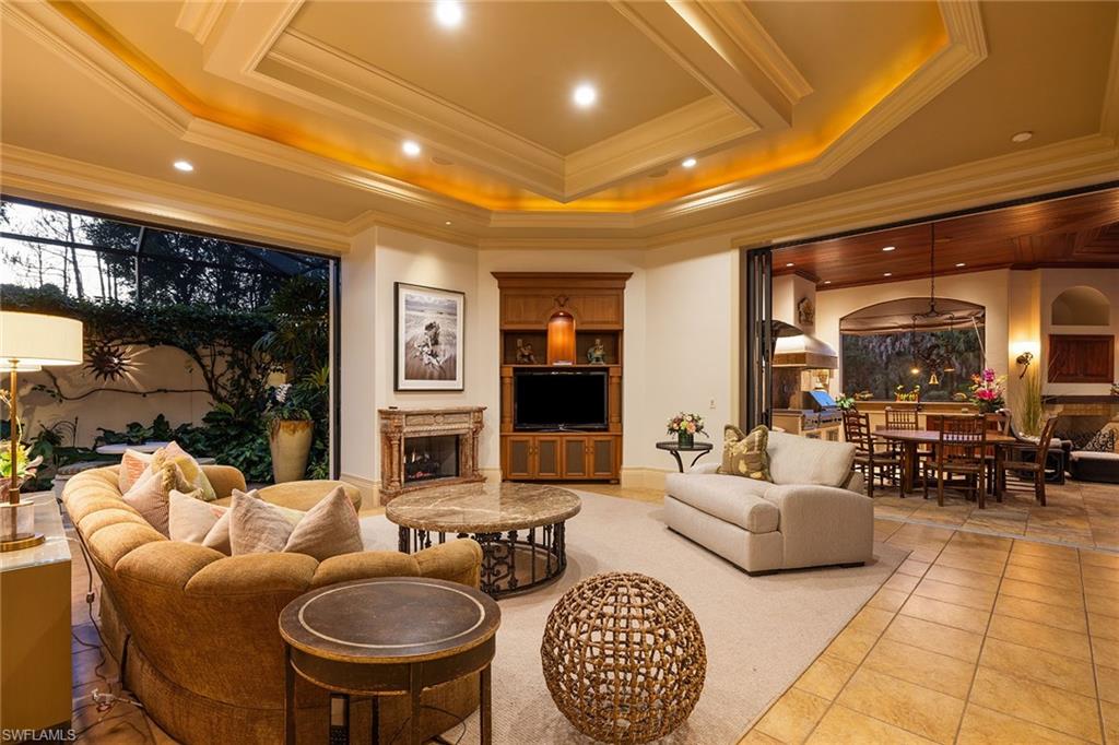 15167 Brolio Lane Naples, FL 34110 - Photo 45 of 50 a living room with furniture a rug and a fireplace