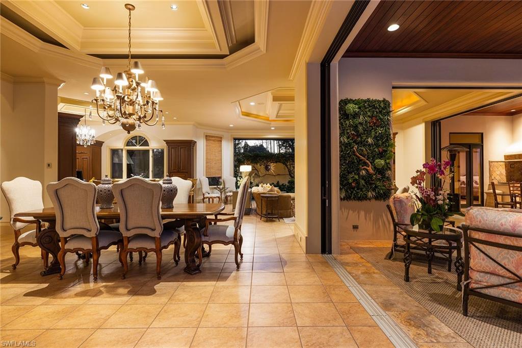 15167 Brolio Lane Naples, FL 34110 - Photo 48 of 50 a view of a dining room with furniture and chandelier