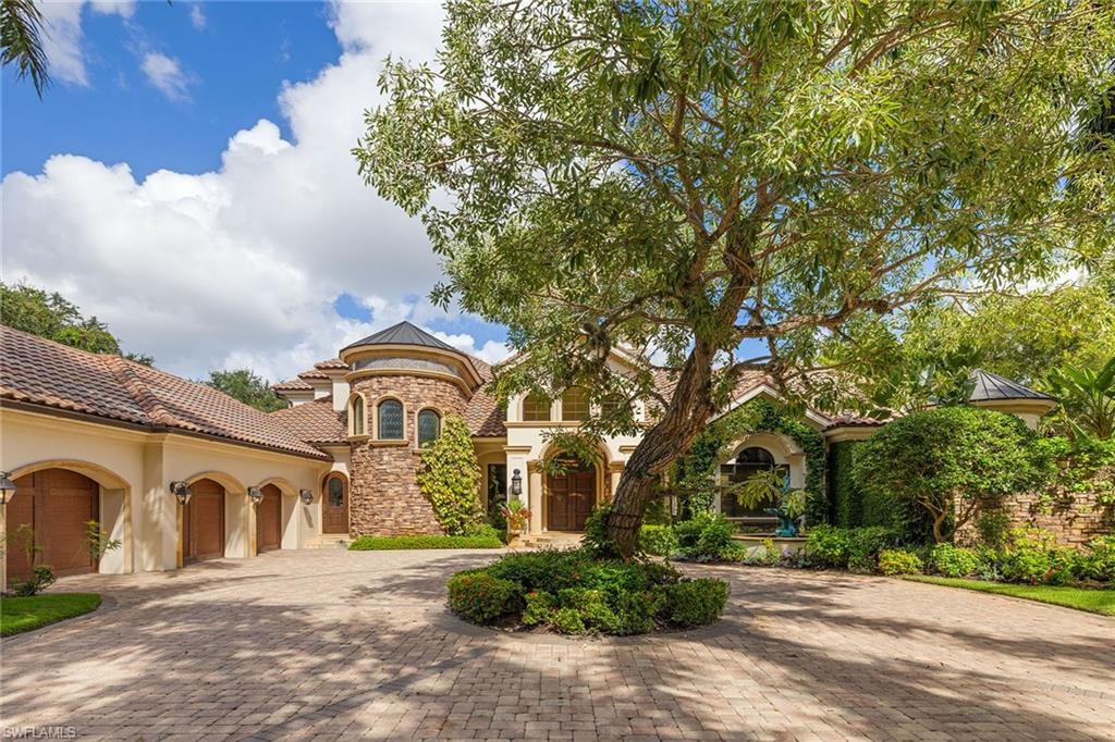 15167 Brolio Lane Naples, FL 34110 - Photo 5 of 50 a front view of a house with garden