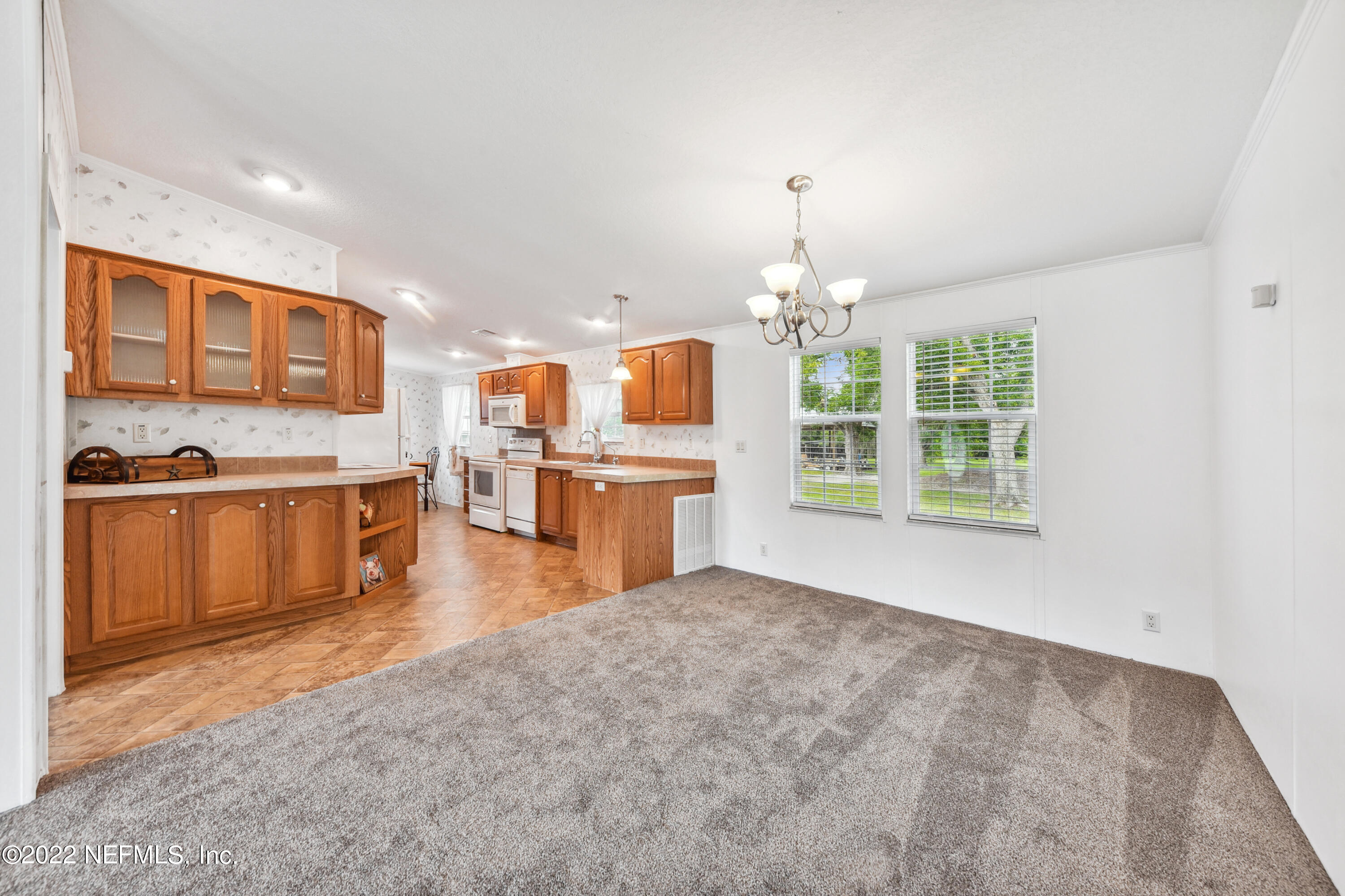 836 Halsema Road South Jacksonville, FL 32221 - Photo 13 of 31 a living room with stainless steel appliances kitchen island furniture and a kitchen view