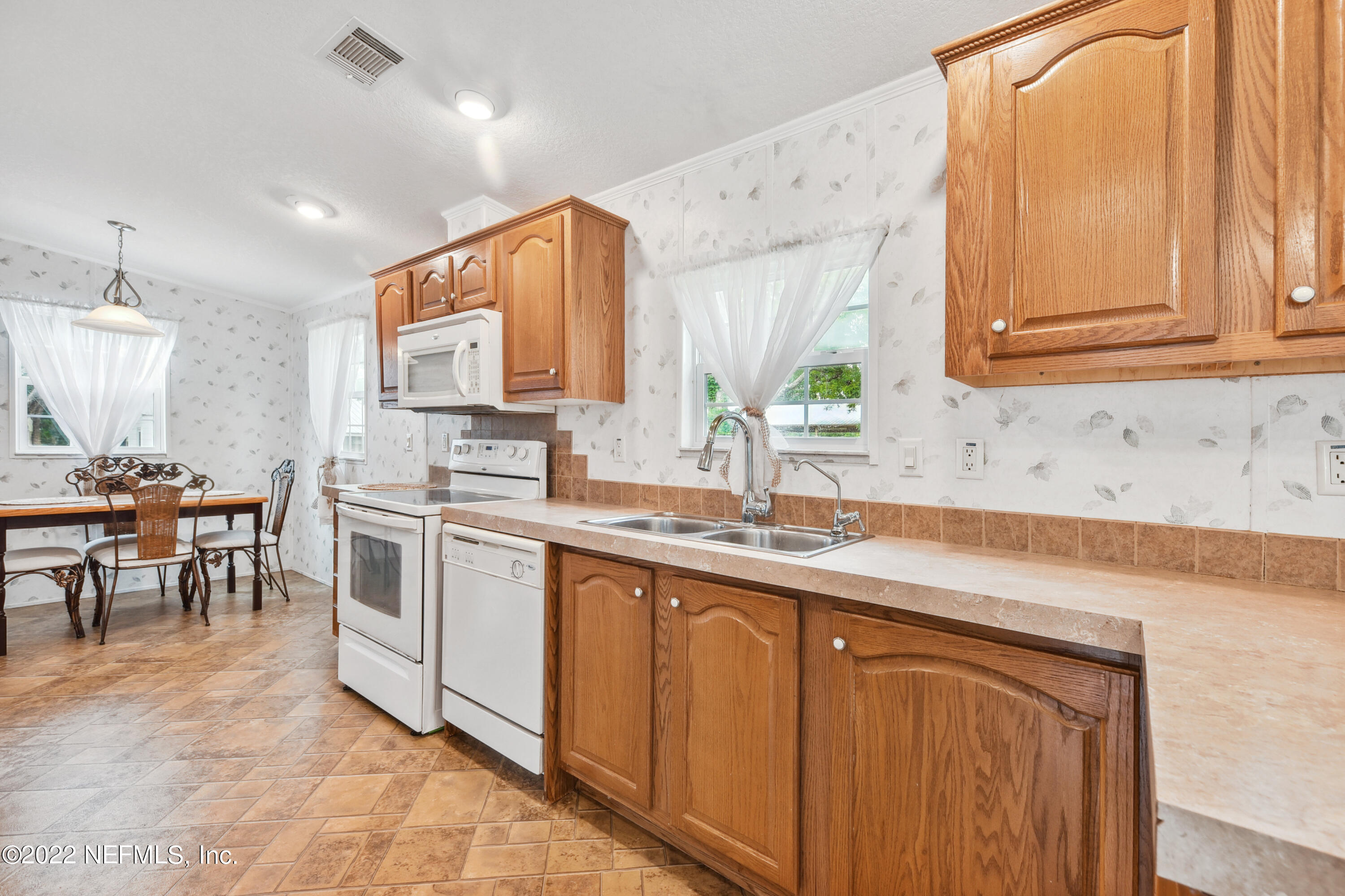 836 Halsema Road South Jacksonville, FL 32221 - Photo 18 of 31 a kitchen with appliances cabinets and a sink