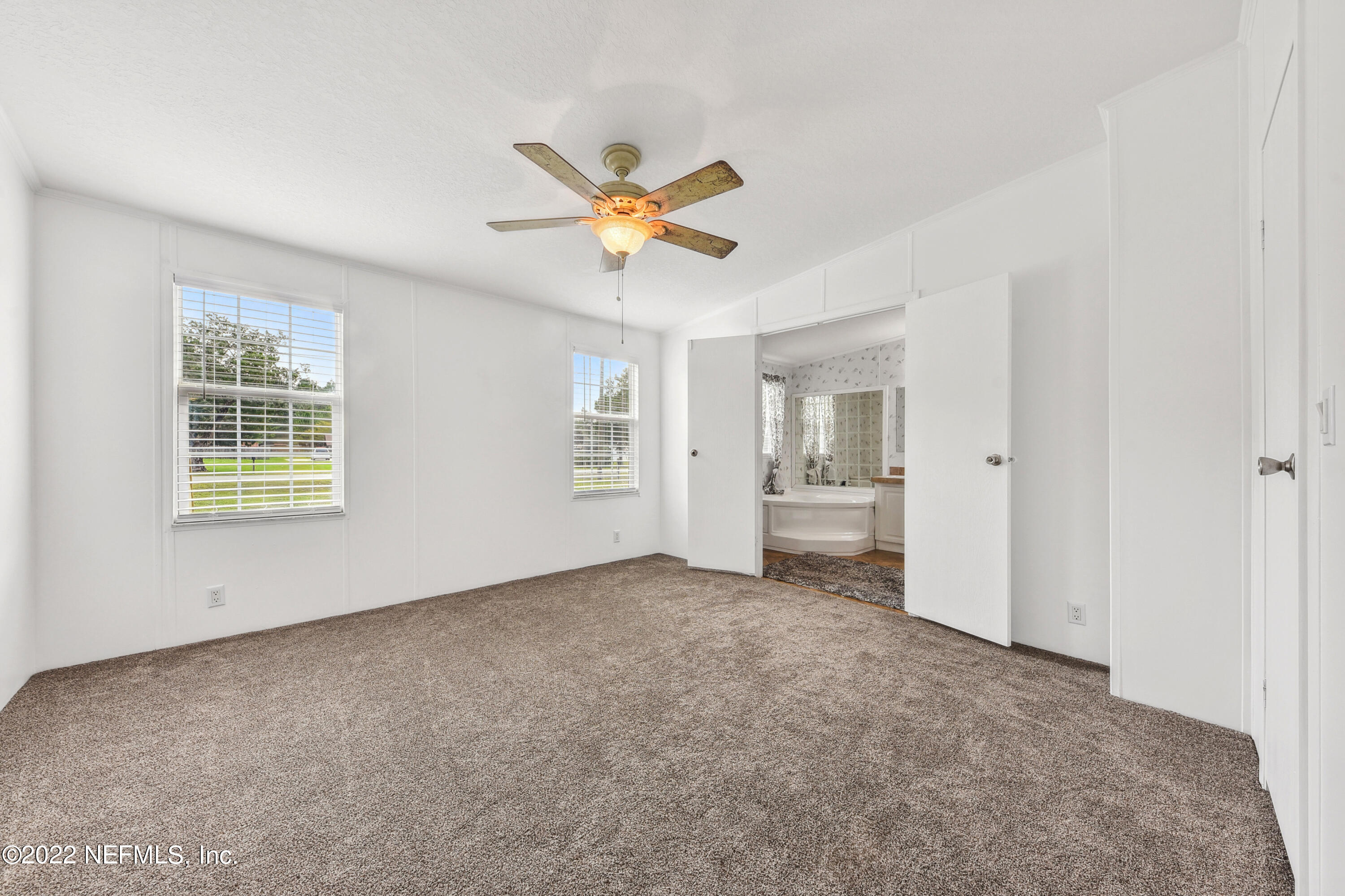 836 Halsema Road South Jacksonville, FL 32221 - Photo 19 of 31 wooden floor in an empty room with a window