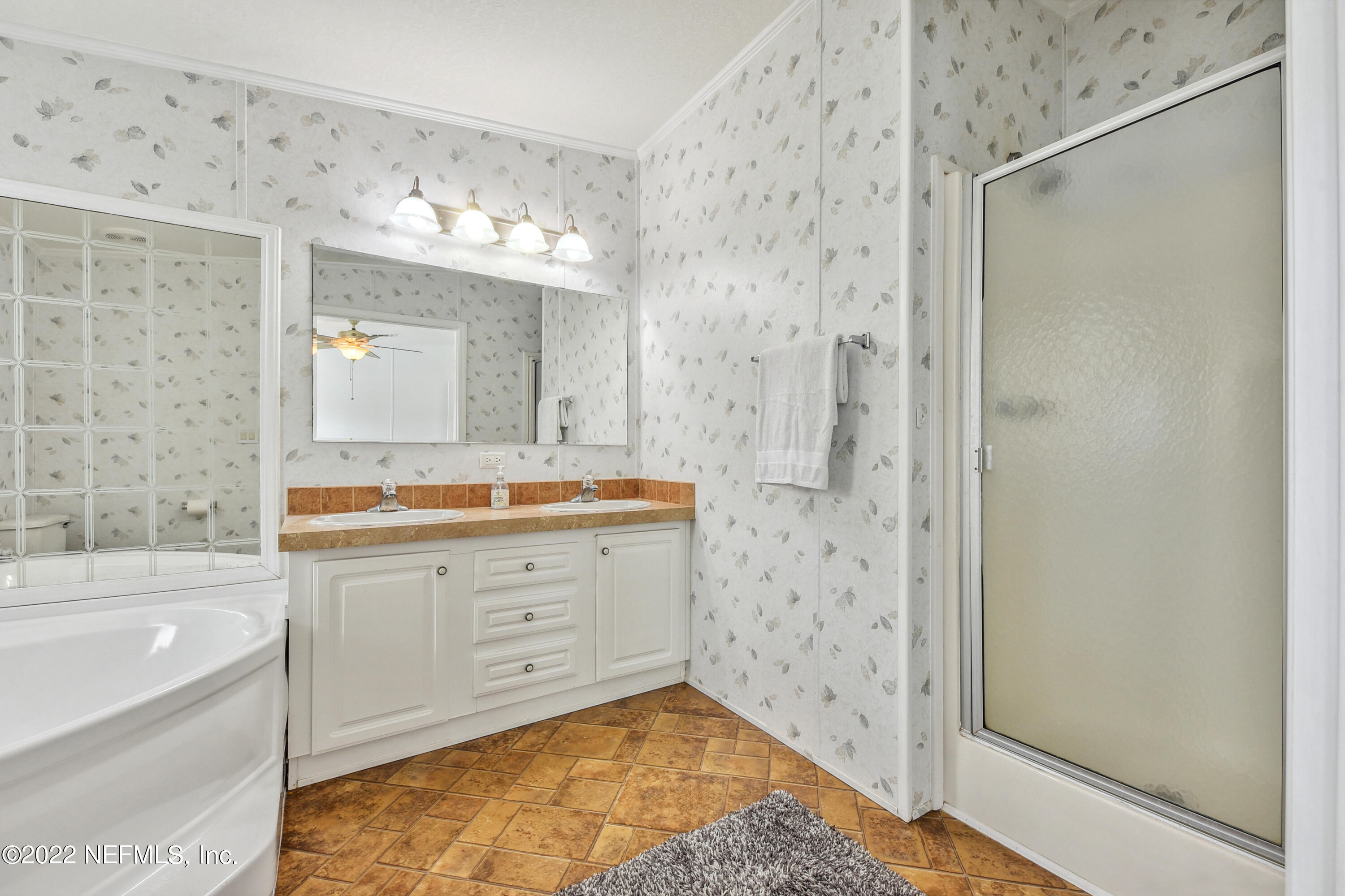 836 Halsema Road South Jacksonville, FL 32221 - Photo 20 of 31 a bathroom with a bathtub sink and mirror