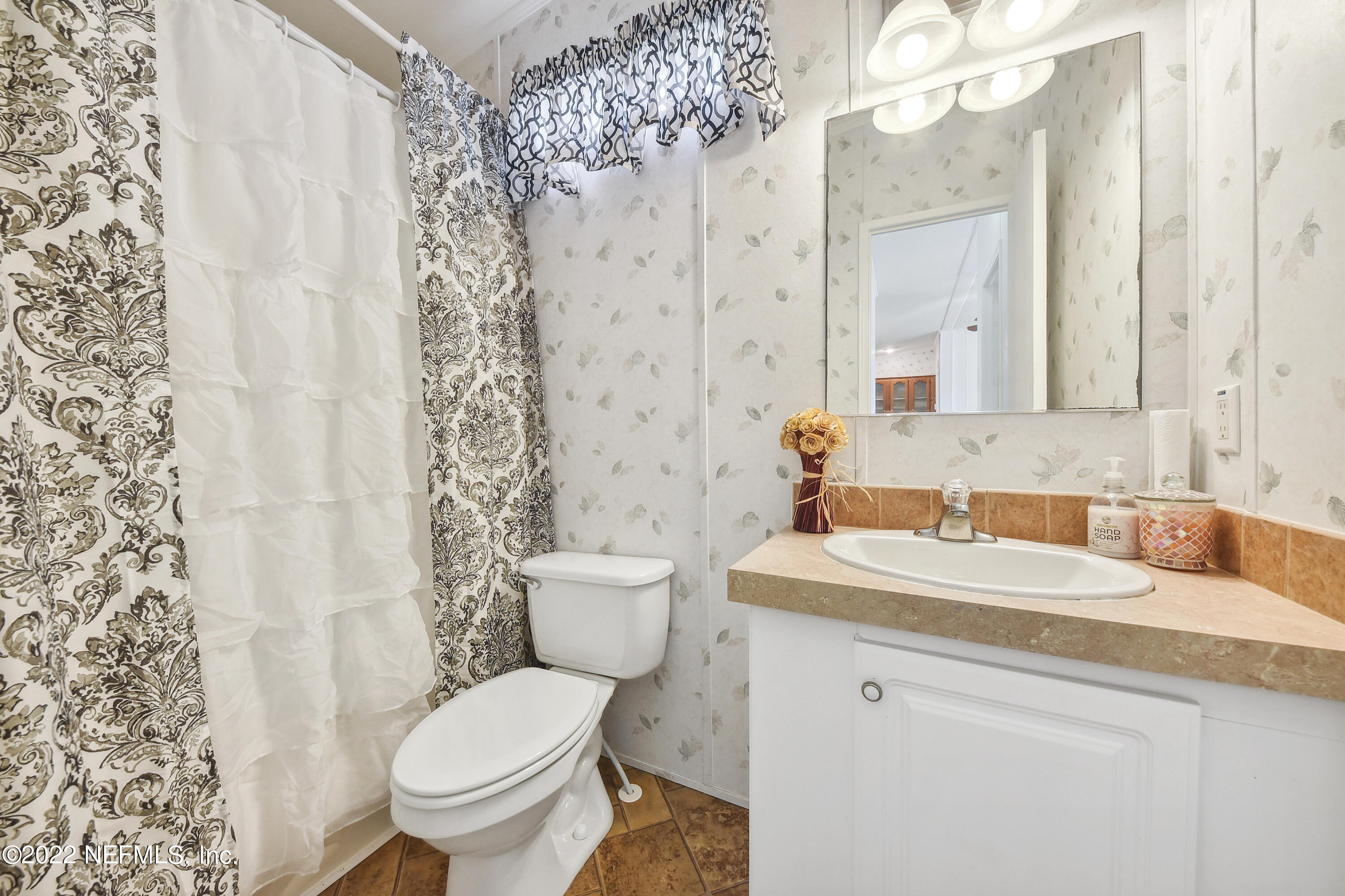 836 Halsema Road South Jacksonville, FL 32221 - Photo 23 of 31 a bathroom with a sink toilet and shower