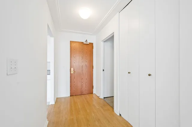 a view of a room with wooden floor
