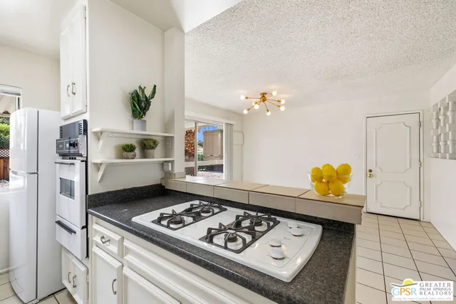 a view of a kitchen with furniture and an empty room