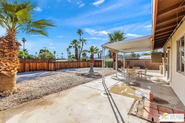 a patio with a table and chairs