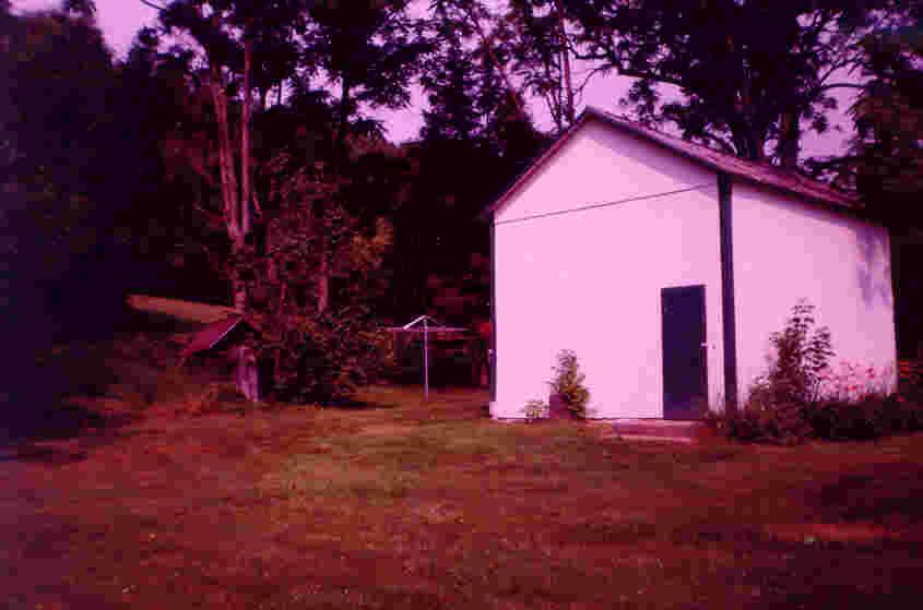 115 Merwinsburg Road Effort, PA 18330 - Photo 6 of 6 a backyard of a house with table and chairs under an umbrella