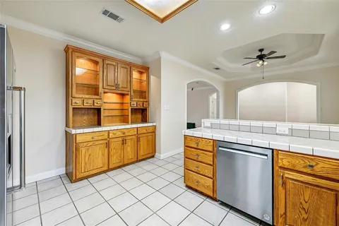a kitchen with stainless steel appliances granite countertop a sink and a stove next to a window