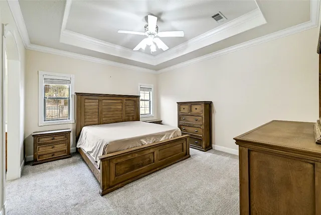 a bedroom with a bed and a chandelier