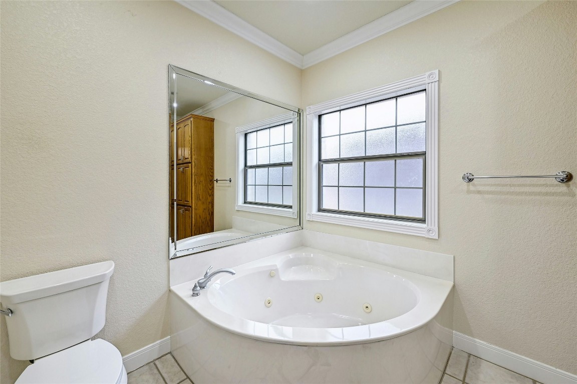 211 Summit Ridge Road Burnet, TX 78611 - Photo 16 of 35 a white bath tub sitting next to a white toilet