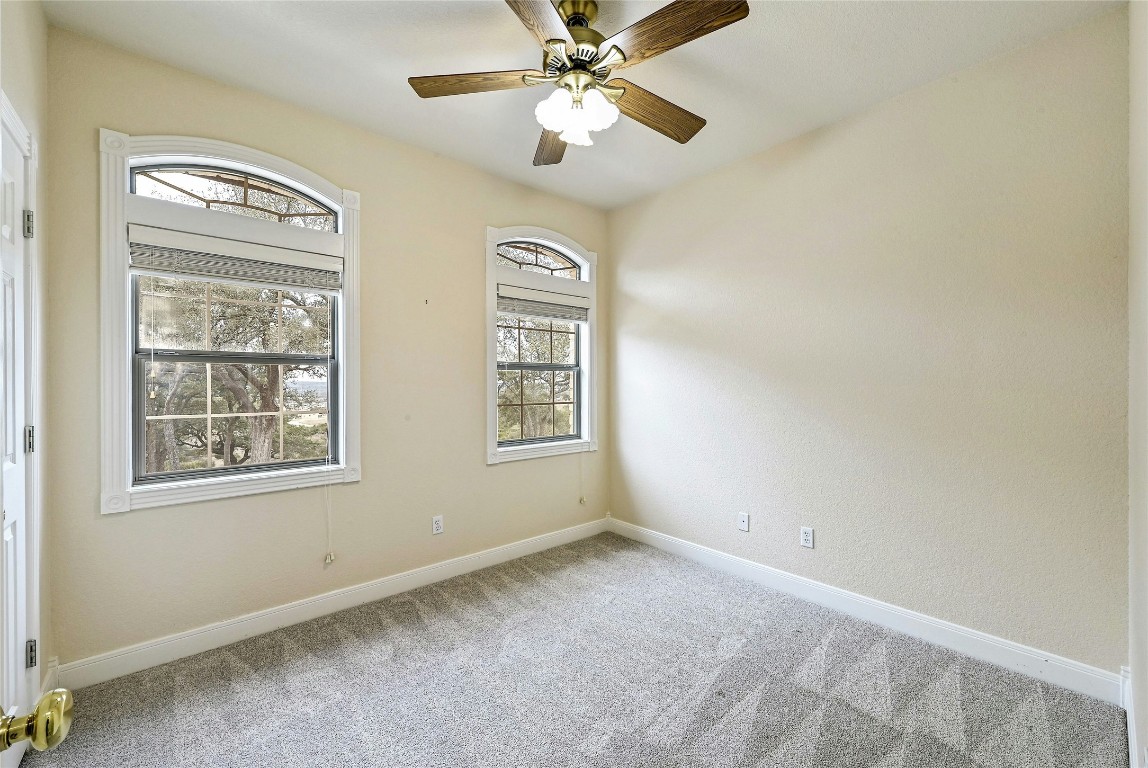 211 Summit Ridge Road Burnet, TX 78611 - Photo 18 of 35 an empty room with windows and fan