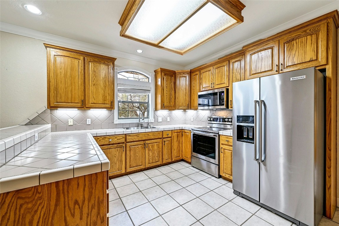 211 Summit Ridge Road Burnet, TX 78611 - Photo 8 of 35 a kitchen with stainless steel appliances granite countertop a refrigerator and a stove top oven