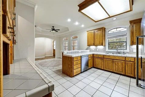 a large kitchen with stainless steel appliances granite countertop a sink and cabinets