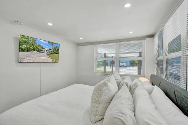 a bed room with a bed and a large window