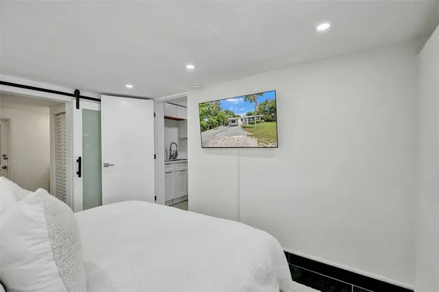 a bedroom with a bed and painting on the wall