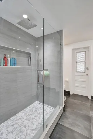 a bathroom with a bathtub and a shower