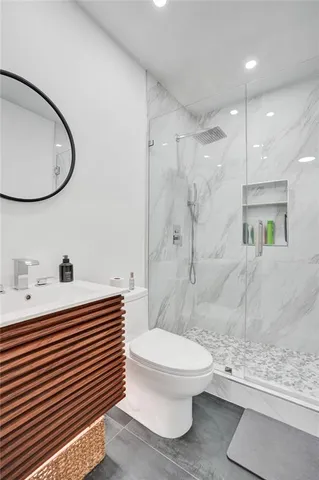 a bathroom with a sink a toilet and a mirror