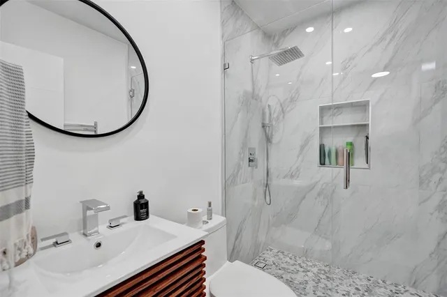 a bathroom with a sink toilet and shower