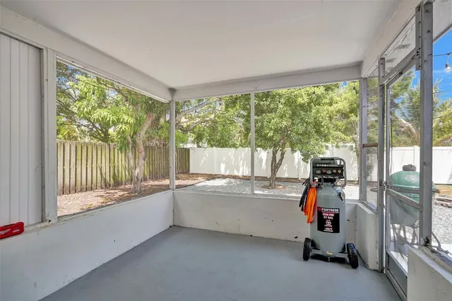 a view of a room with gym equipment and a large window