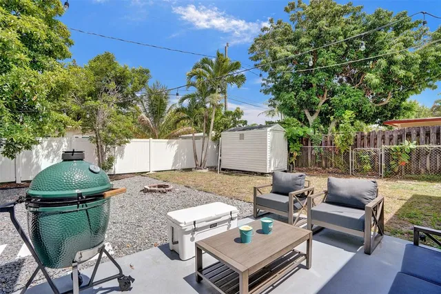 a view of a patio with couches table and chairs and potted plants