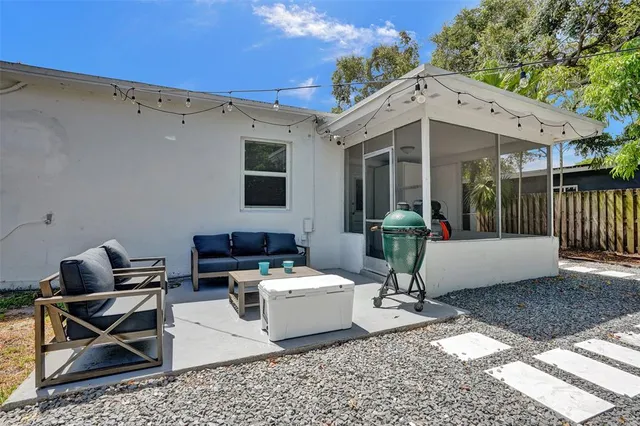 a view of a backyard with table and chairs under an umbrella