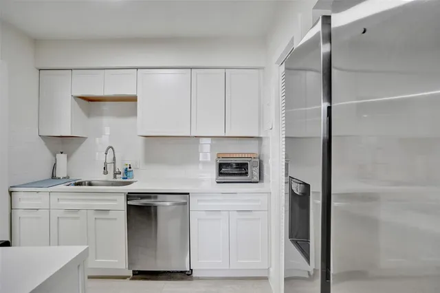 a kitchen with cabinets and white appliances