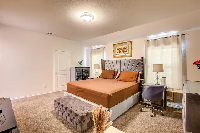 a bedroom with a bed furniture and a book shelf