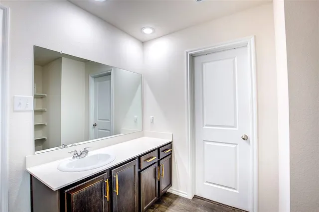 a bathroom with a double vanity sink and mirror