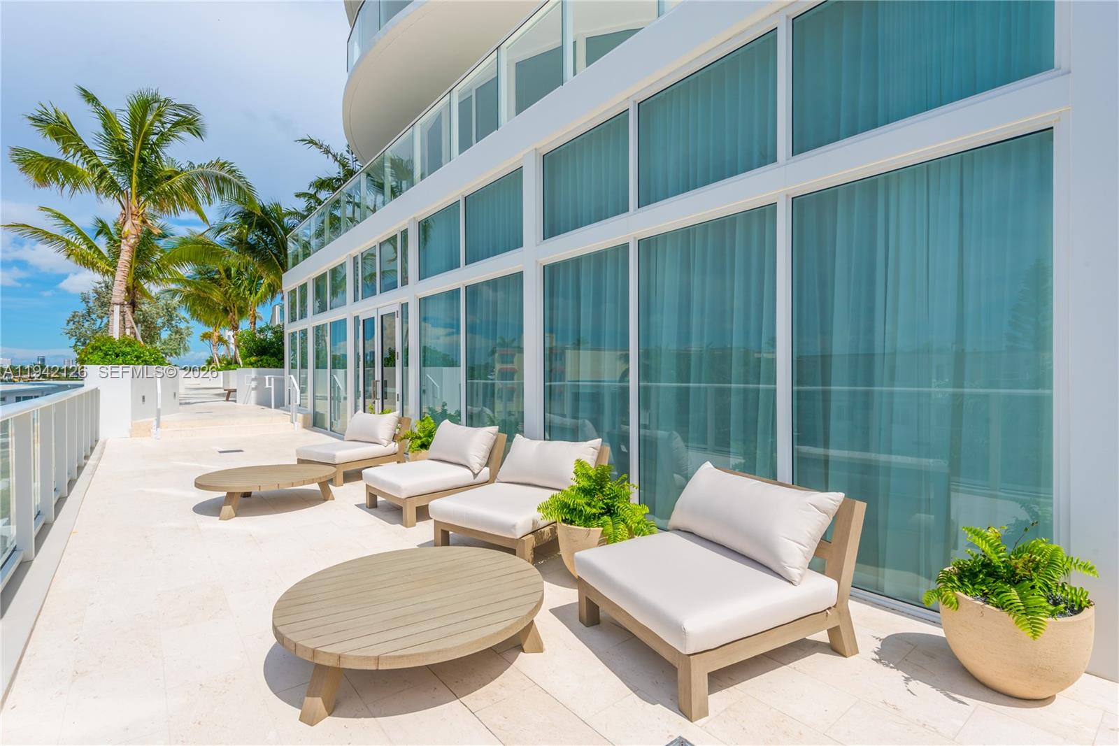 401 North Birch Road, Unit 701 Fort Lauderdale, FL 33304 - Photo 48 of 75 a view of a patio with couches table and chairs and potted plants