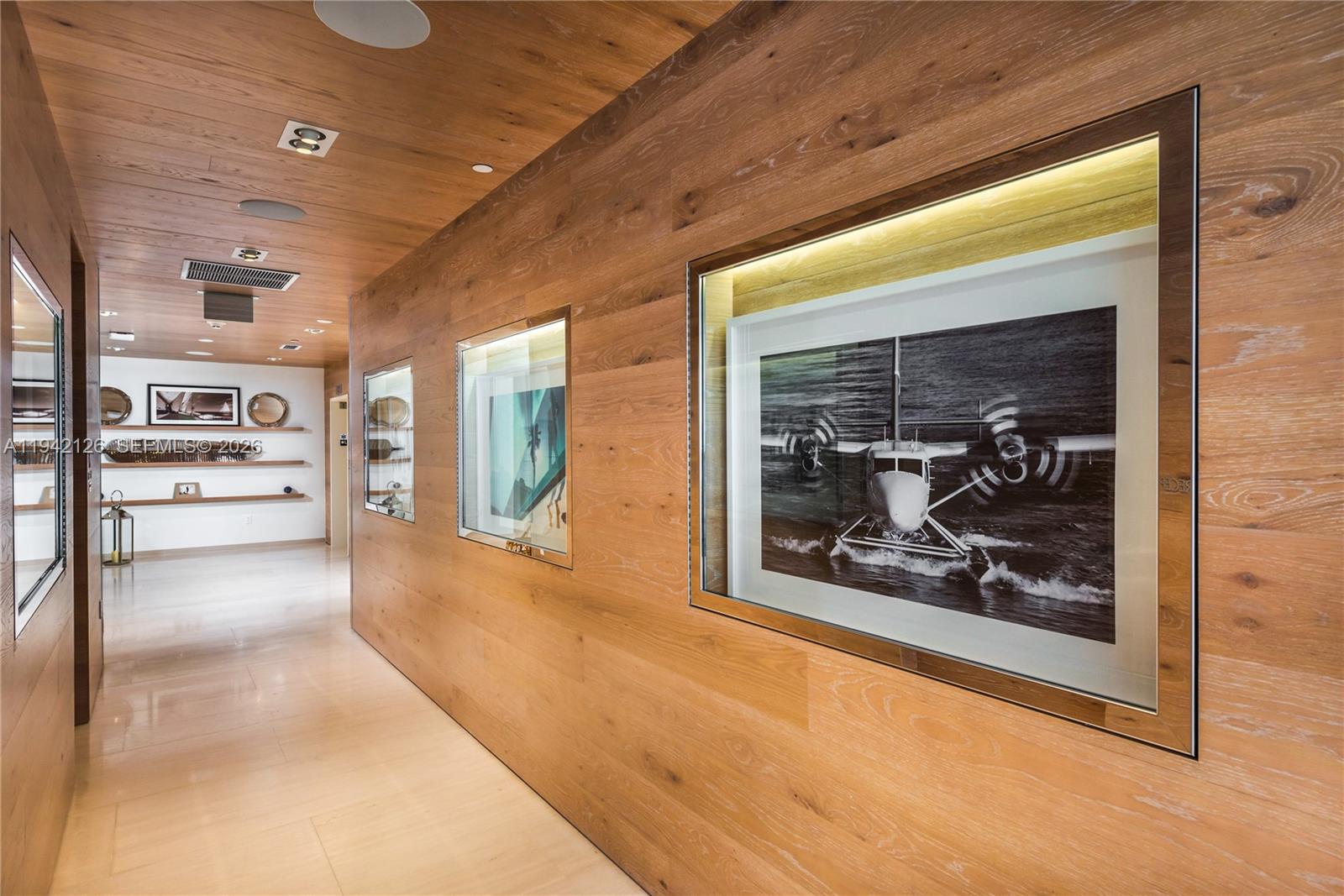 401 North Birch Road, Unit 701 Fort Lauderdale, FL 33304 - Photo 55 of 75 a view of a hallway with wooden floor and a fireplace
