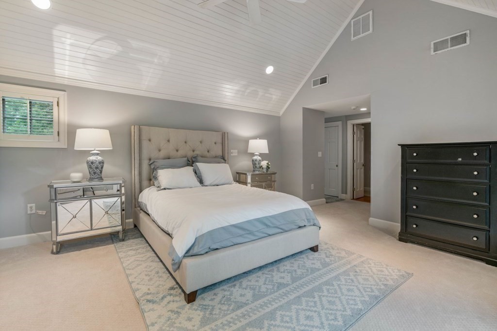 15 Woodridge Road Wellesley, MA 02482 - Photo 20 of 36 a spacious bedroom with a bed and a lamp