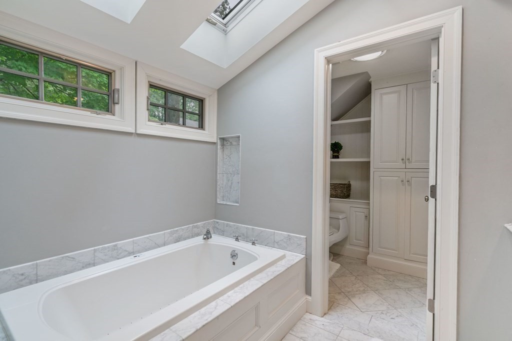 15 Woodridge Road Wellesley, MA 02482 - Photo 22 of 36 a bathroom with a tub shower and sink