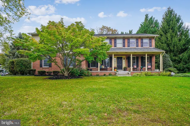 a view of a house with a yard and sitting area