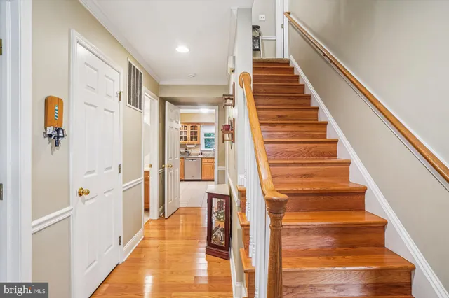 a view of an entryway with wooden floor and staircase