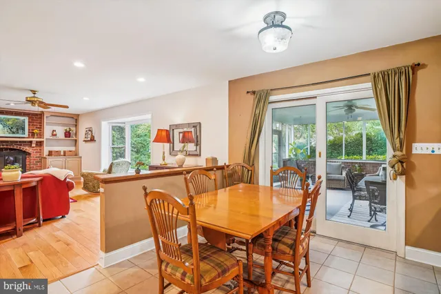 a dining room with furniture a chandelier and window