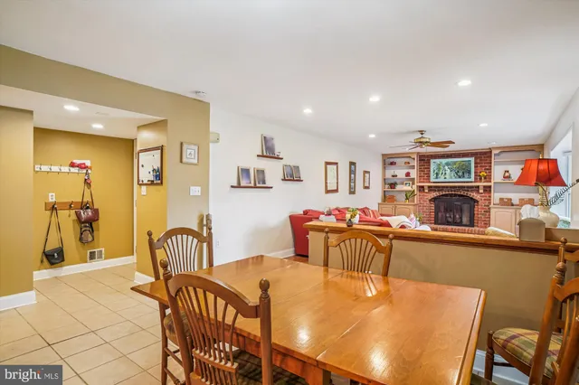 a dining room with furniture a chandelier and wooden floor