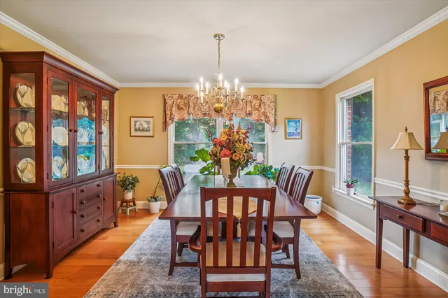 a view of a dining room with furniture and chandelier