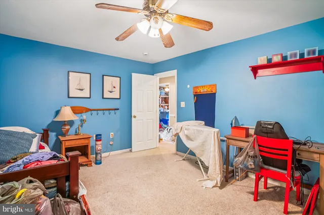 a bathroom with a window a toilet and a shower