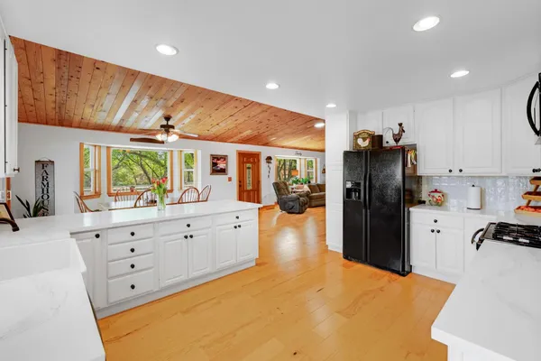 a kitchen with stainless steel appliances a refrigerator sink and cabinets