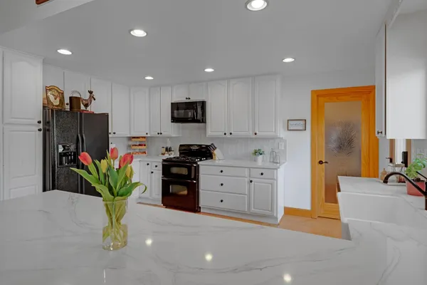 a storage room with lots of clutter and lots of frames on the wall