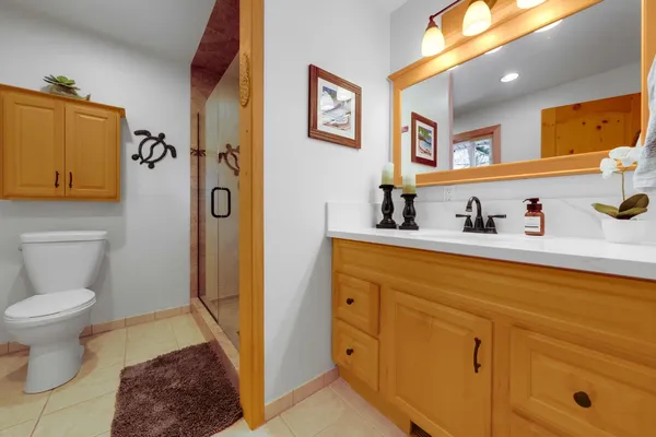 a bathroom with a granite countertop shower a mirror and a shower