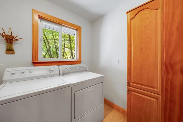 a view of a house with a tree in the yard