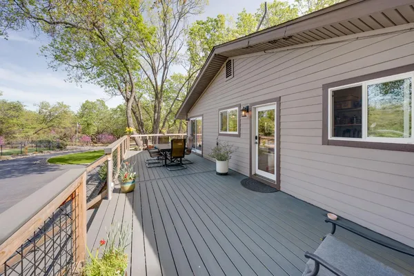 a view of a house with a backyard and a tree