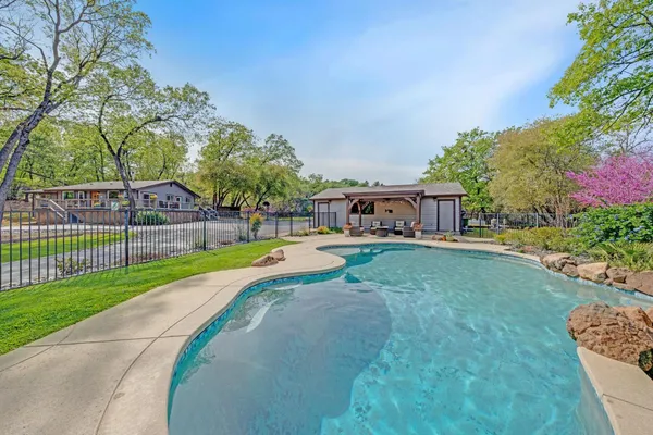 a view of a house with a large tree