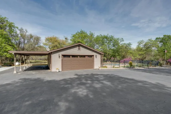 a bedroom with a bed and a view of living room