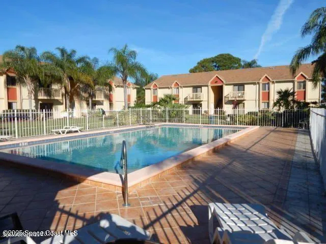 a view of a swimming pool with a patio