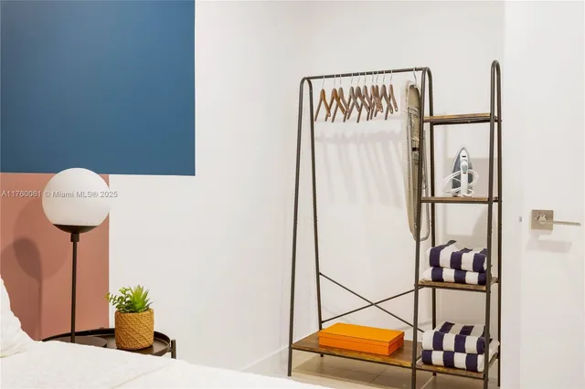 a picture of a room with furniture and a potted plant