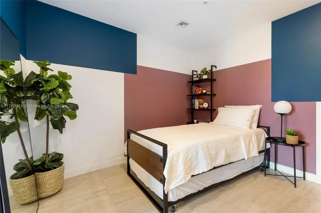 a bedroom with a bed potted plant and a potted plant