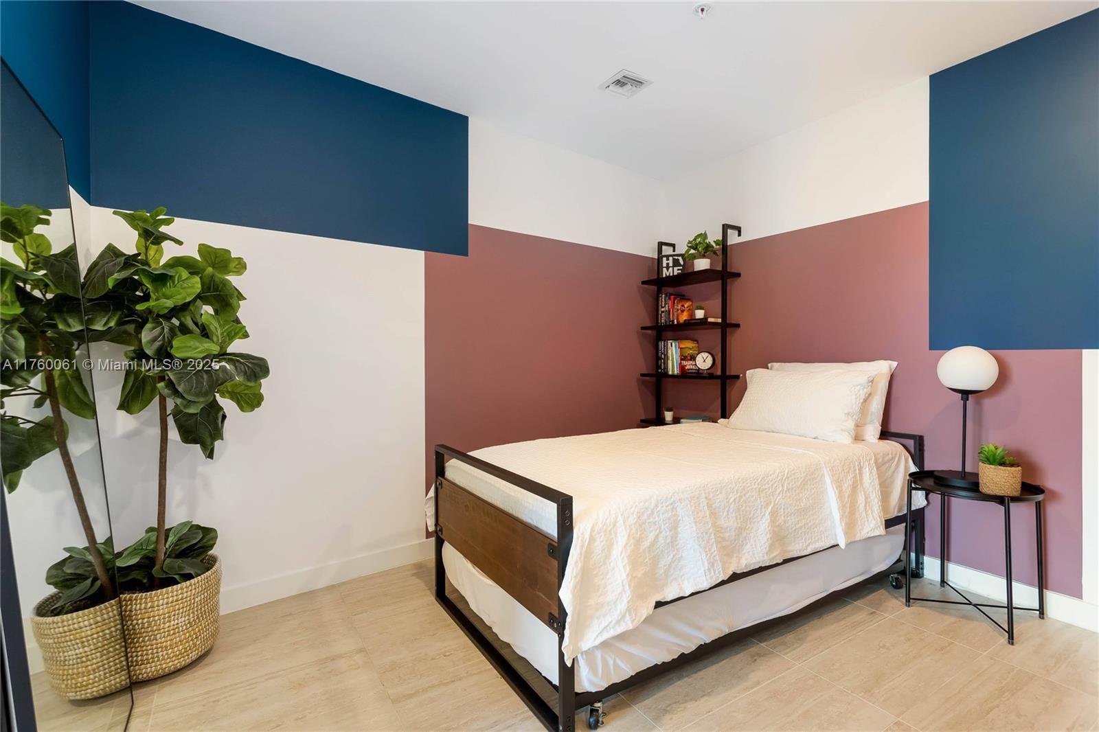 3900 Biscayne Boulevard, Unit S314 Miami, FL 33137 - Photo 14 of 15 a bedroom with a bed potted plant and a potted plant